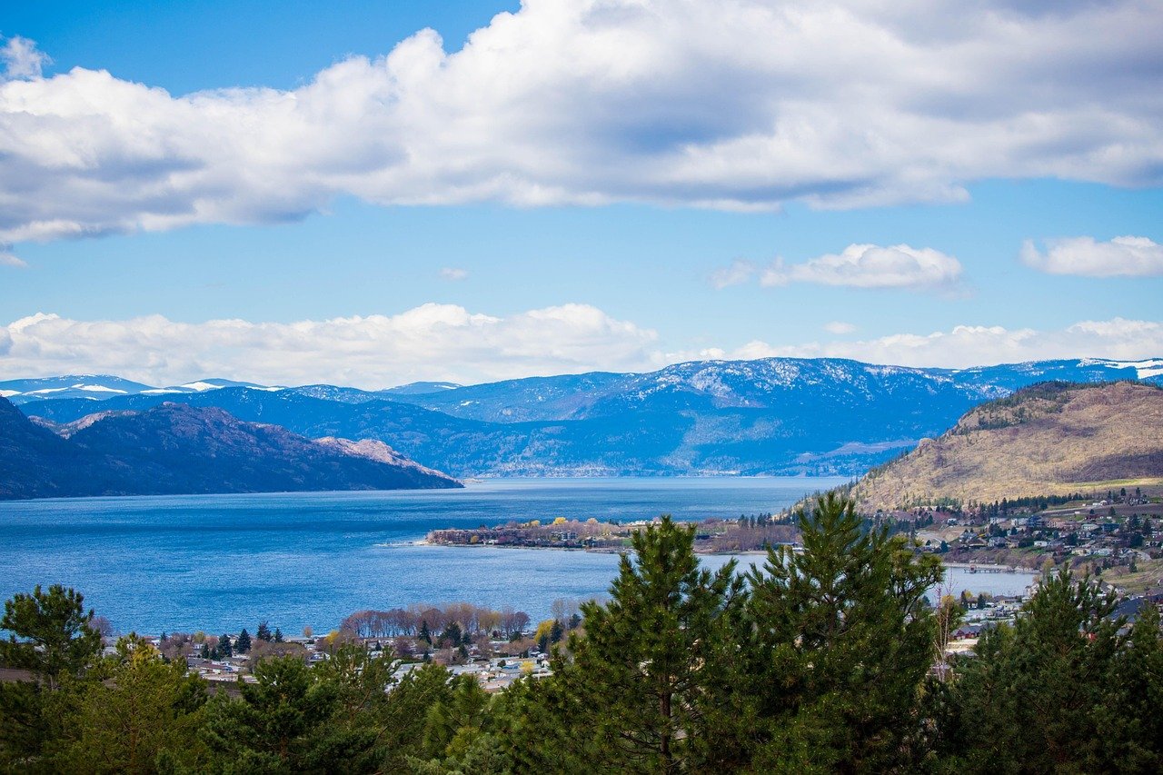 View over Okanagan Lake and a lakeside community with mountains beyond