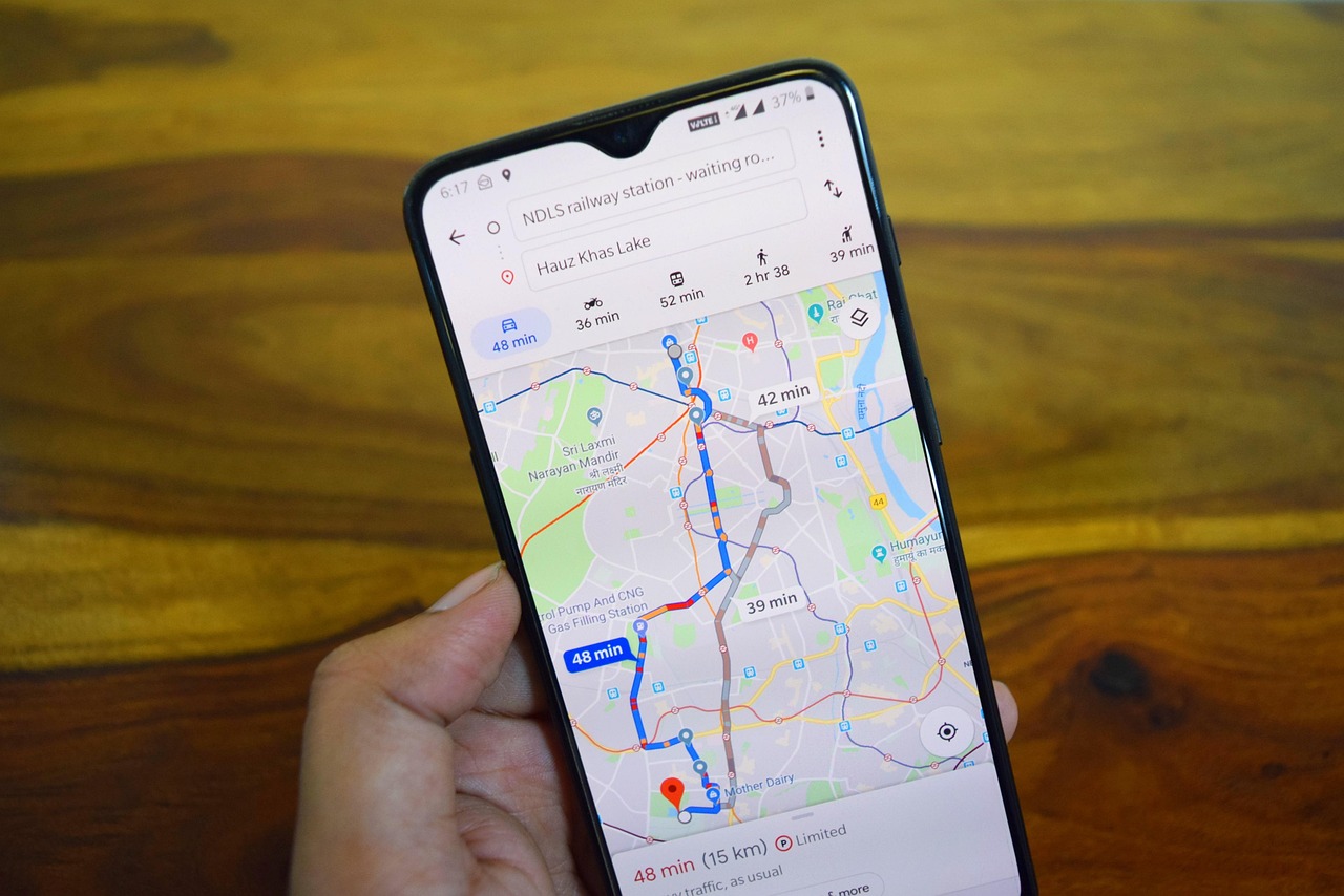 Hand holding a smartphone showing a maps app with a route