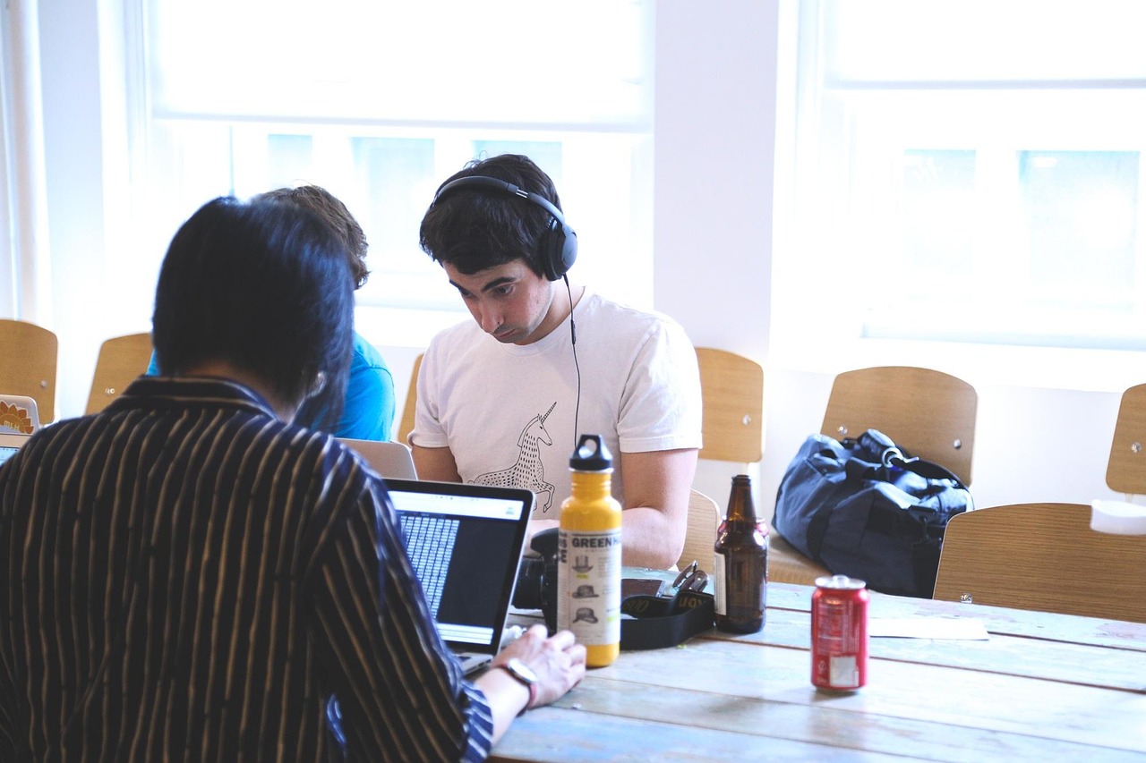 Two people working together on a laptop at a table