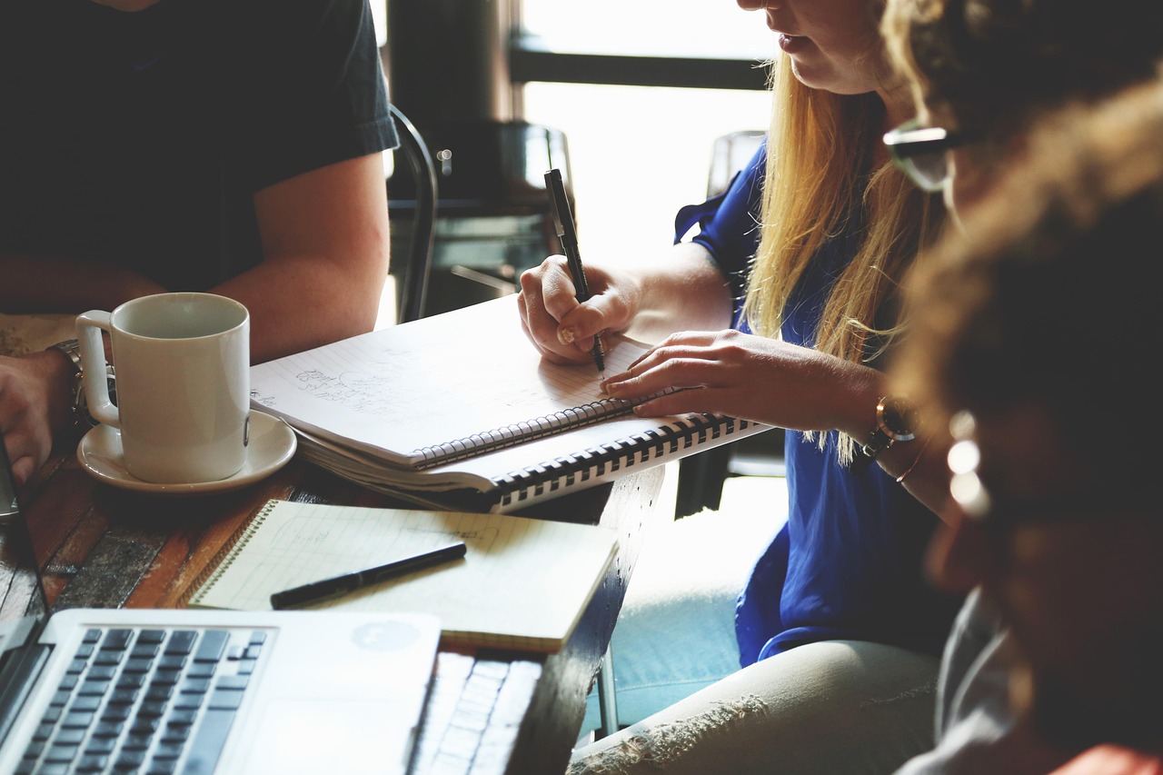 Team members planning notes together around a table